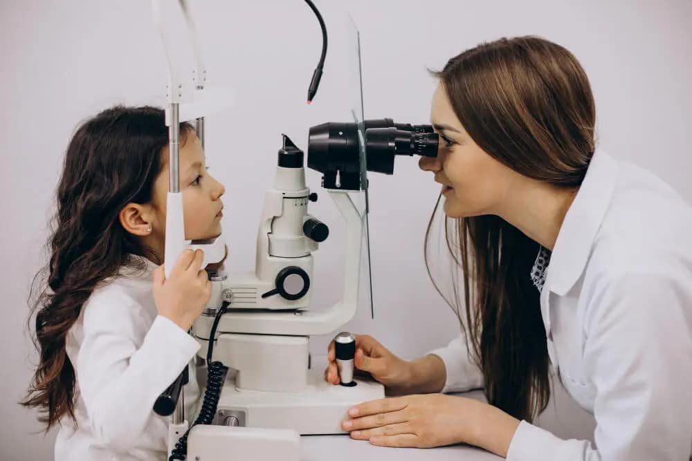 child having eyes tested by optician