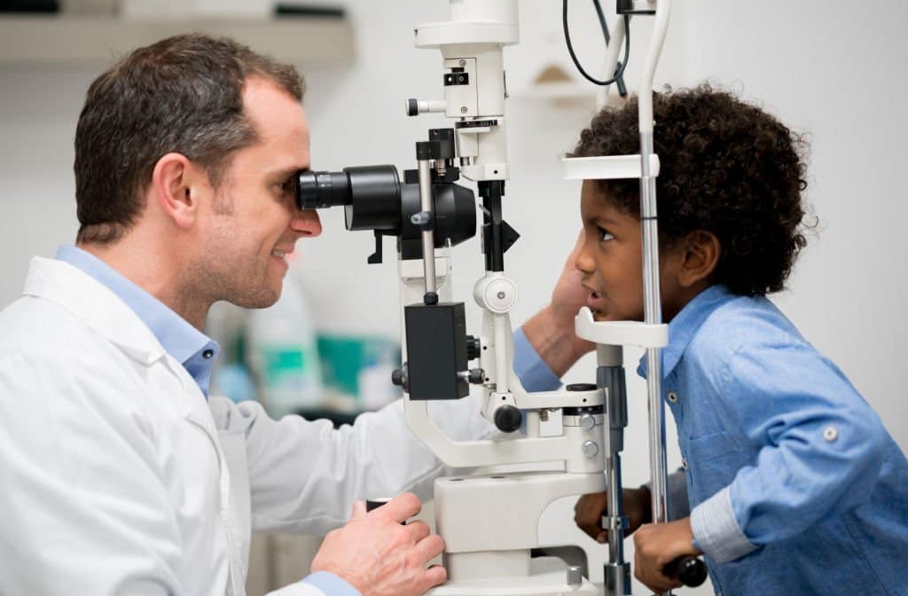 child having eyes tested by optician