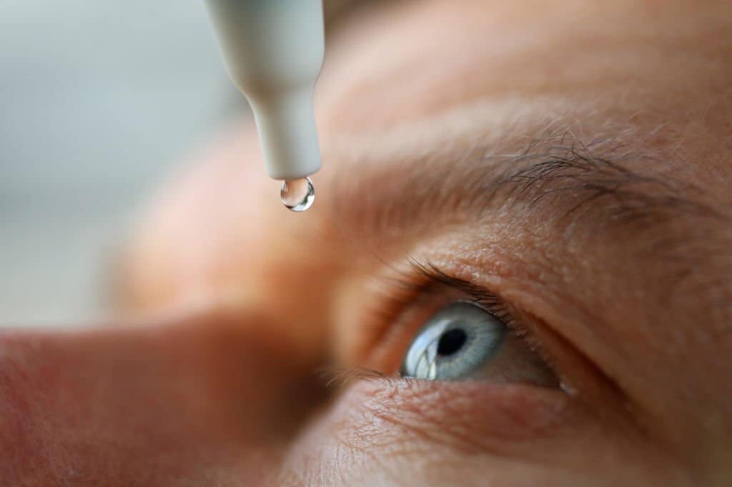 close up of drops being applied to a person's eye