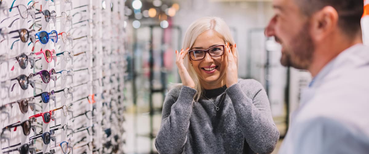 lady trying on glasses in an opticians
