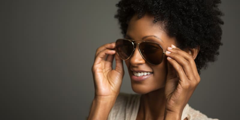 close up of female model's face wearing designer sunglasses